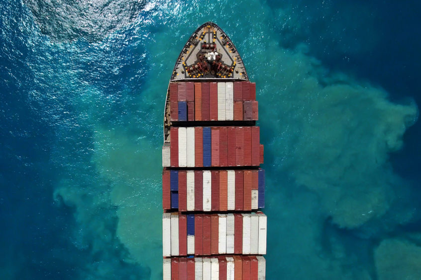 Mega container ship at sea - Top down aerial view