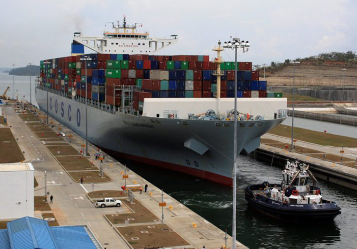 COSCO freight ship passing through the Panama canal