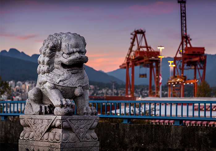 Chinese statue with a sea port in the background