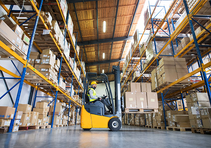 Forklift organizing pallets in a warehouse