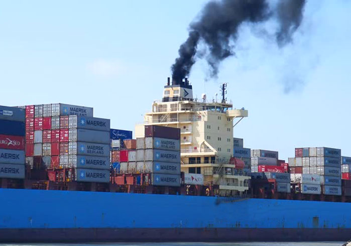 Freight ship blowing black smoke